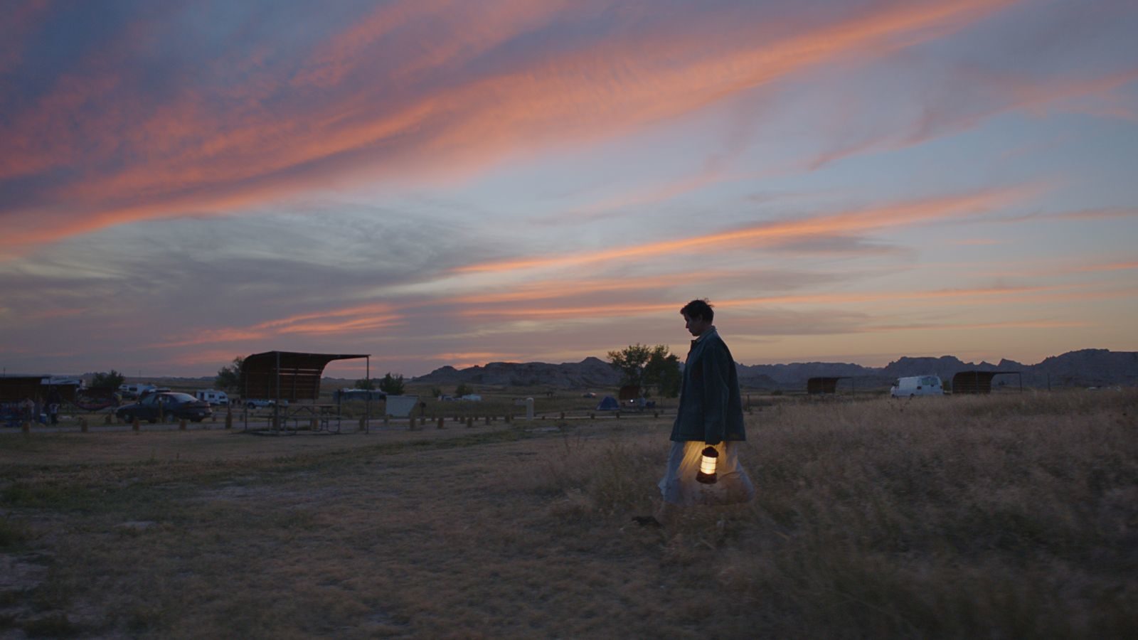 Frances McDormand wanders with a lantern in Chloe Zhao's film Nomadland